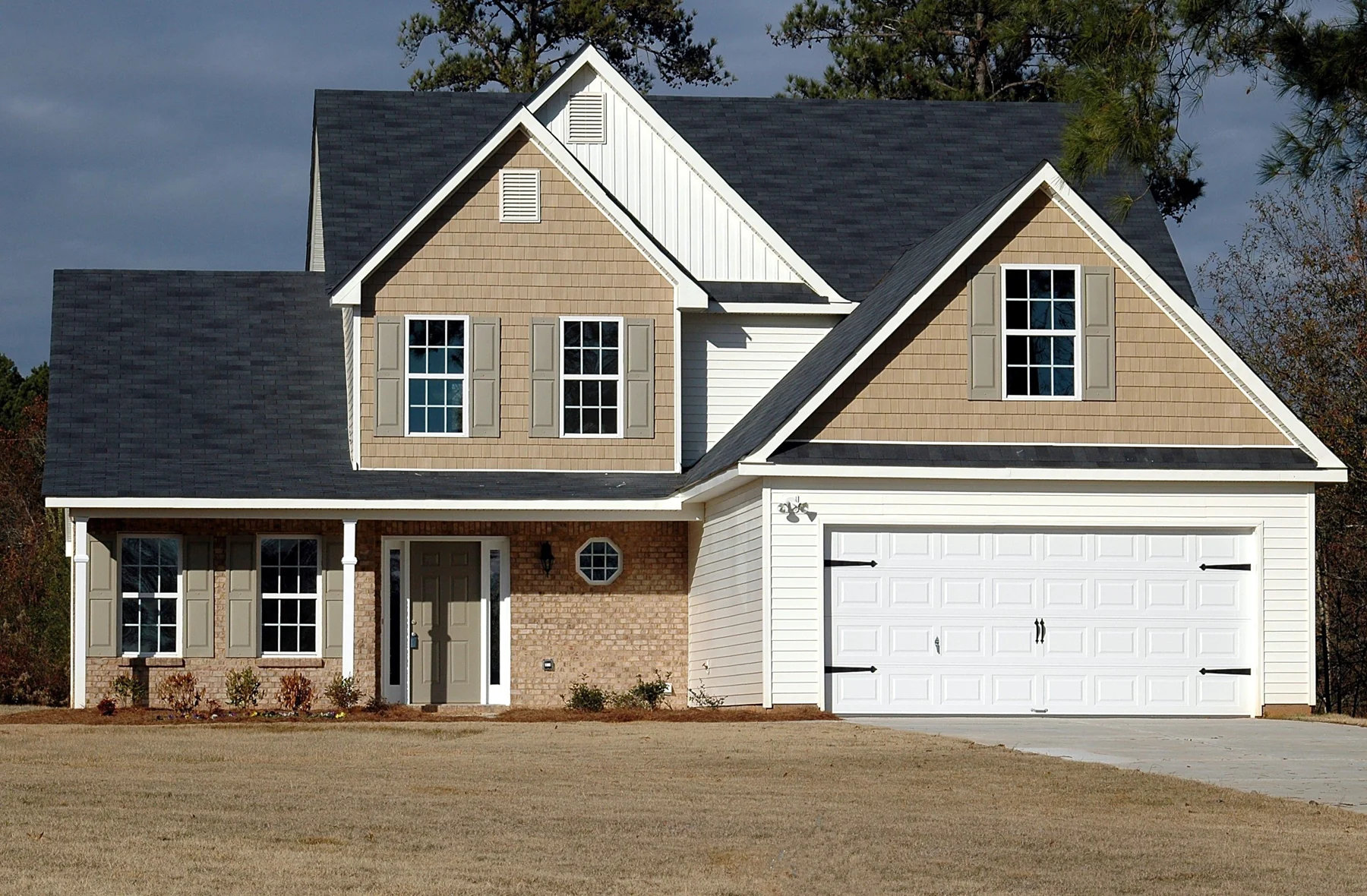 A two-storey house with an asphalt-shingle roof and garage